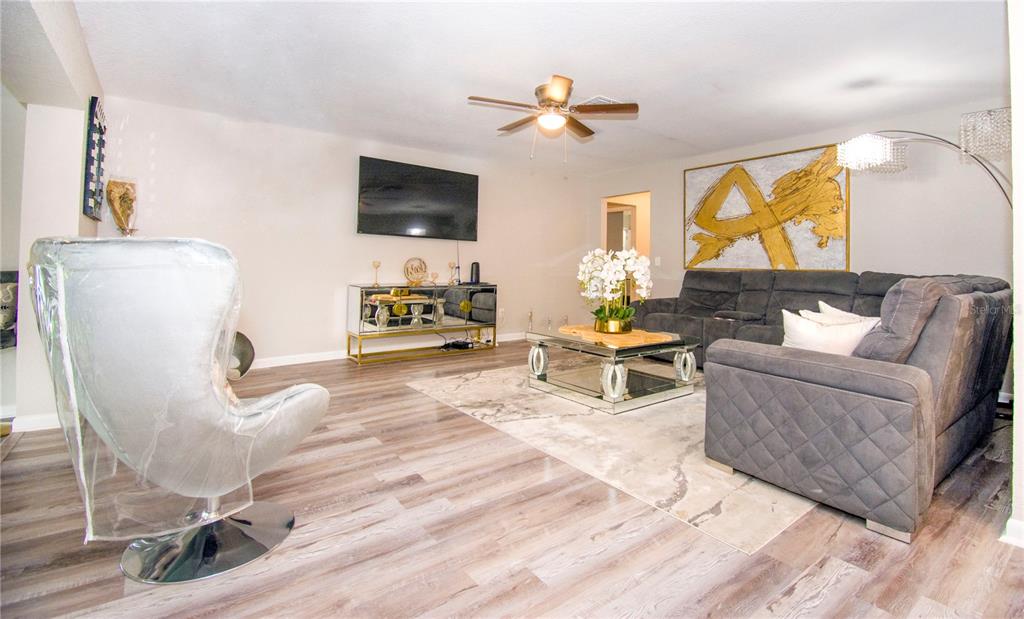 1504 Hallam Drive Lakeland, FL 33813 - Photo 7 of 34 a living room with furniture and a flat screen tv