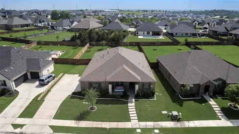 an aerial view of a house with yard swimming pool and outdoor seating