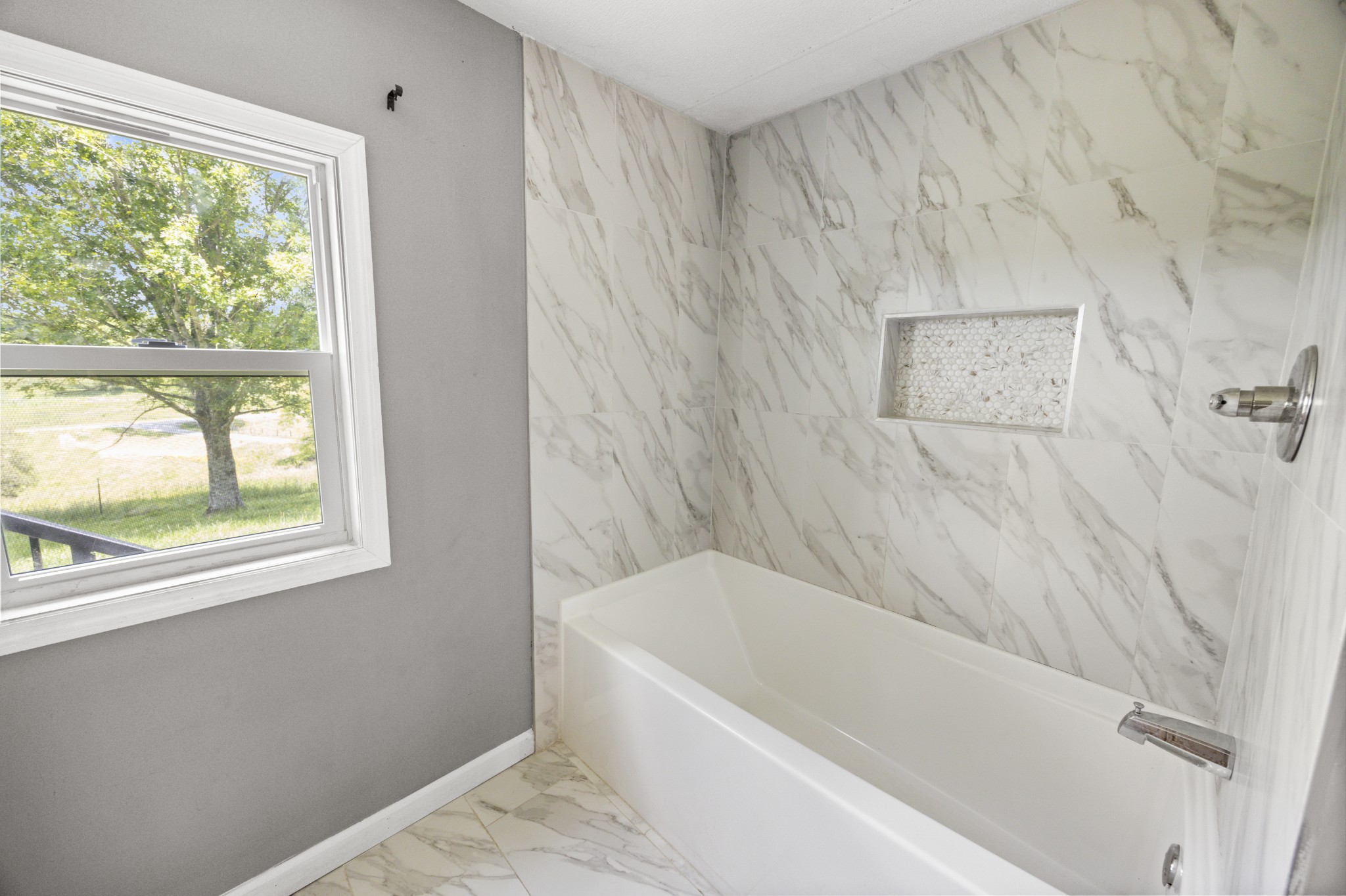 4455 Browning Branch Road Bethpage, TN 37022 - Photo 9 of 19 a white bath tub sitting next to a window