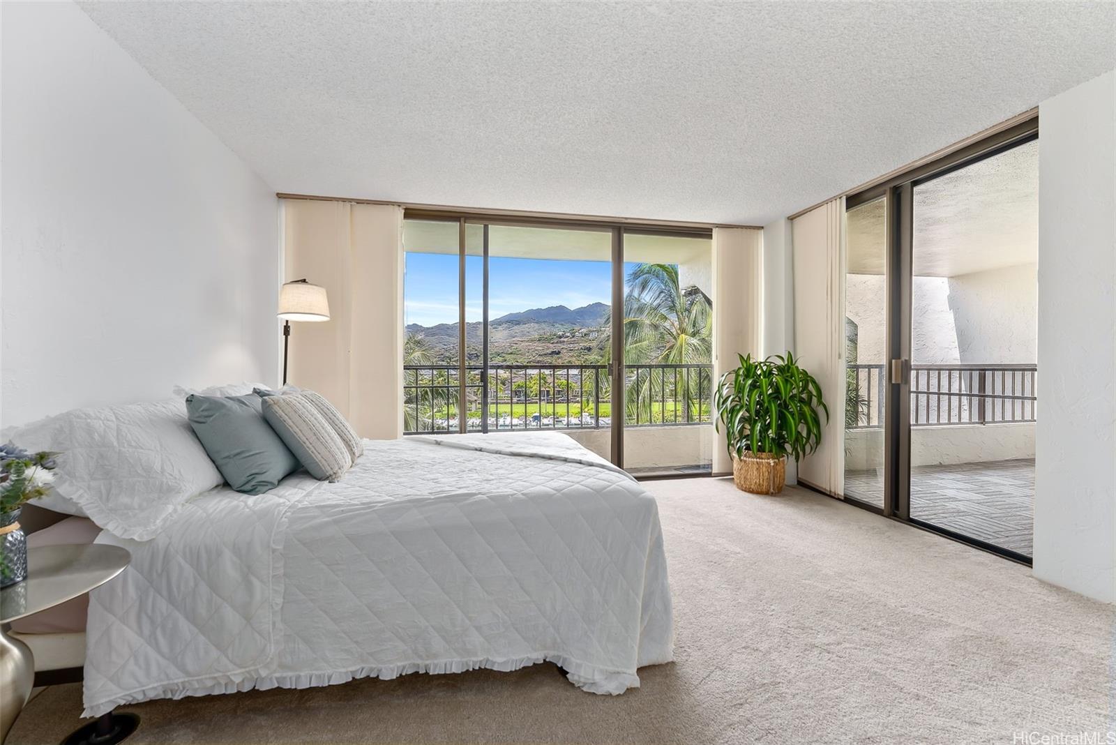 500 Lunalilo Home Road, Unit 25B Honolulu, HI 96825 - Photo 11 of 23 a large bed sitting in a room next to a window