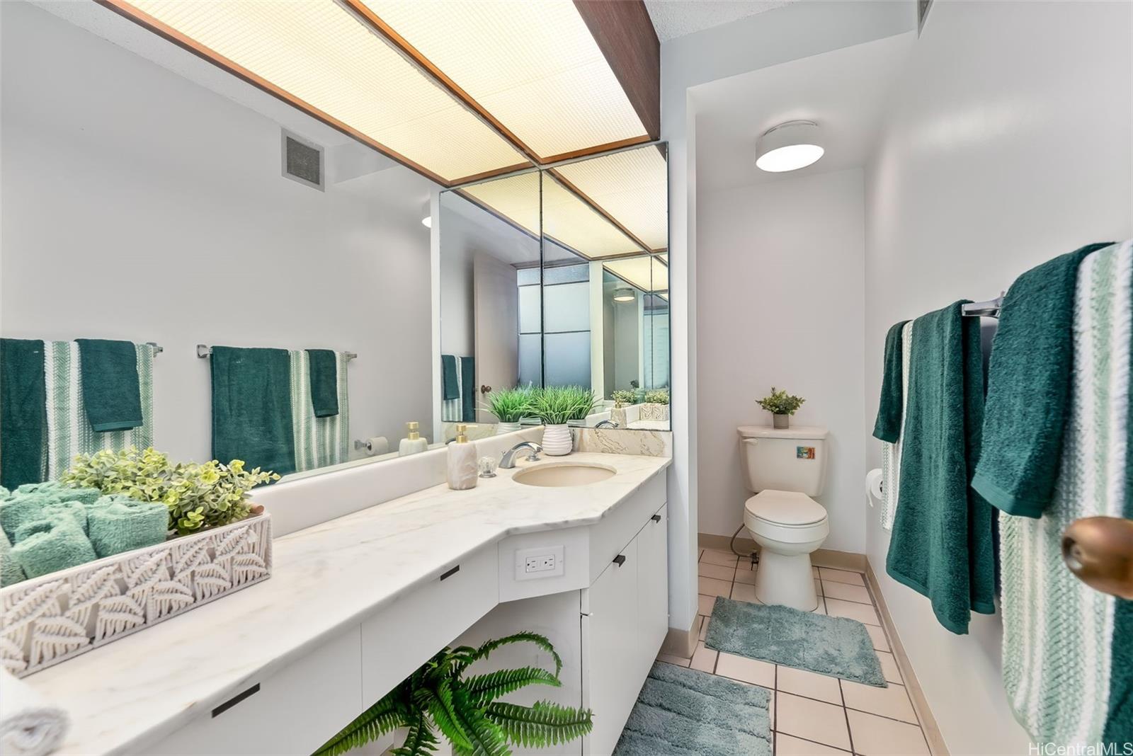 500 Lunalilo Home Road, Unit 25B Honolulu, HI 96825 - Photo 14 of 23 a bathroom with a granite countertop sink toilet and shower
