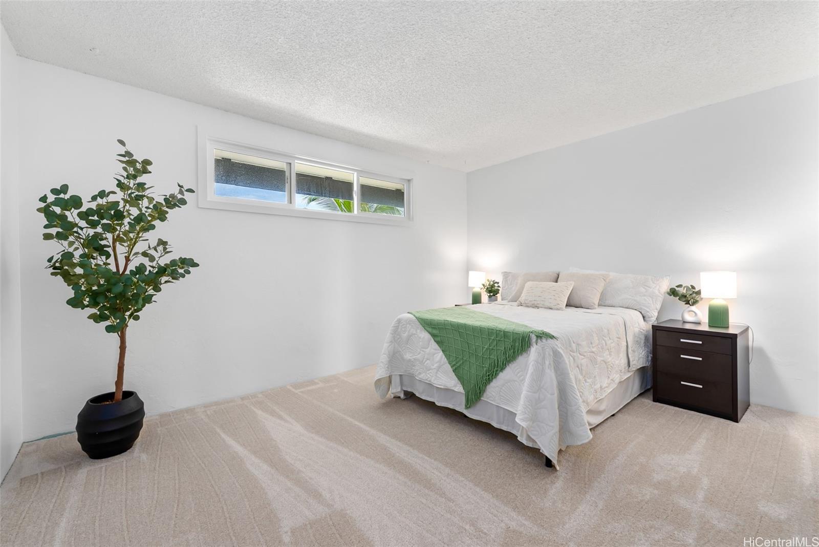 500 Lunalilo Home Road, Unit 25B Honolulu, HI 96825 - Photo 16 of 23 a bedroom with a bed and a potted plant