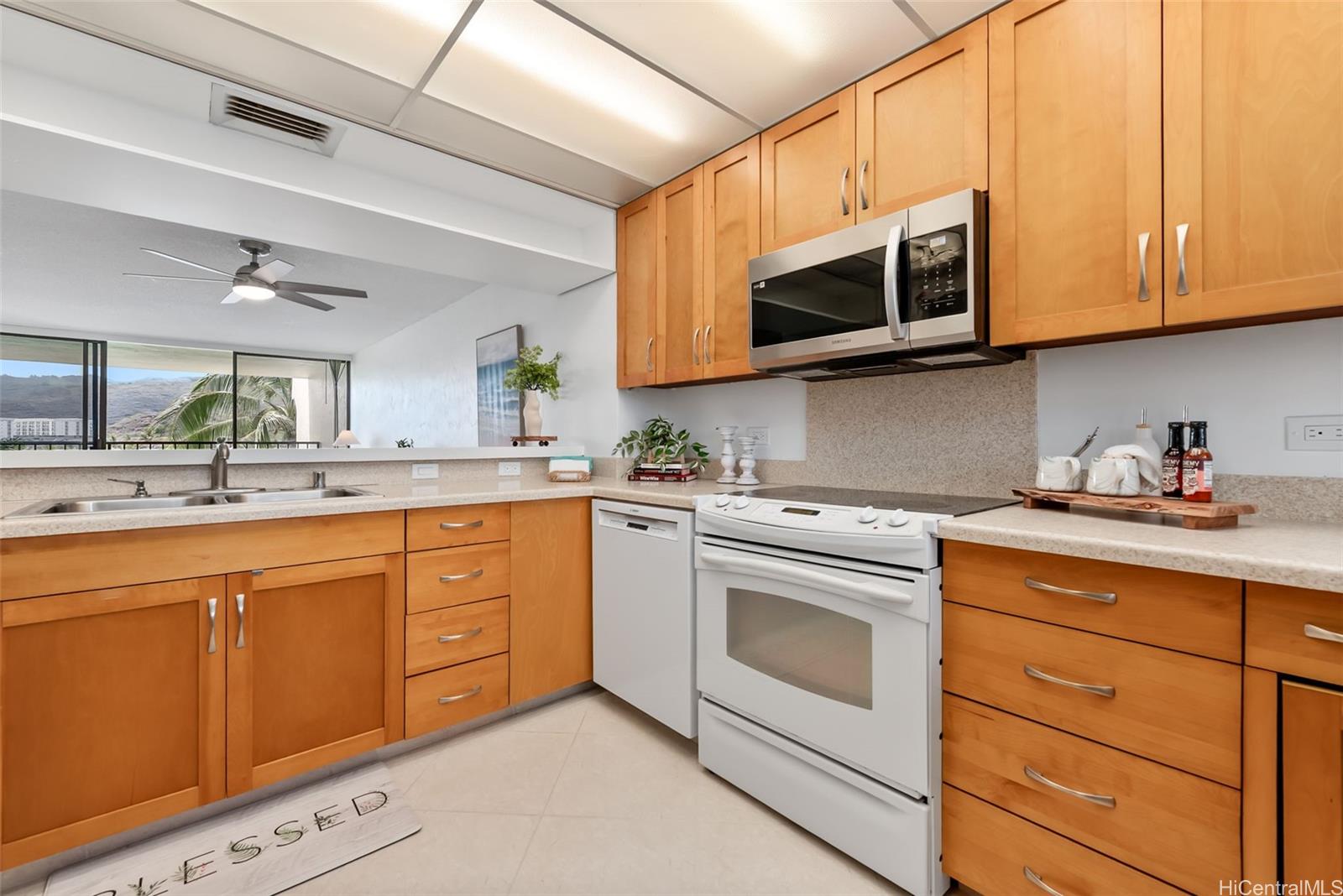 500 Lunalilo Home Road, Unit 25B Honolulu, HI 96825 - Photo 4 of 23 a kitchen with stainless steel appliances granite countertop white cabinets a sink and dishwasher