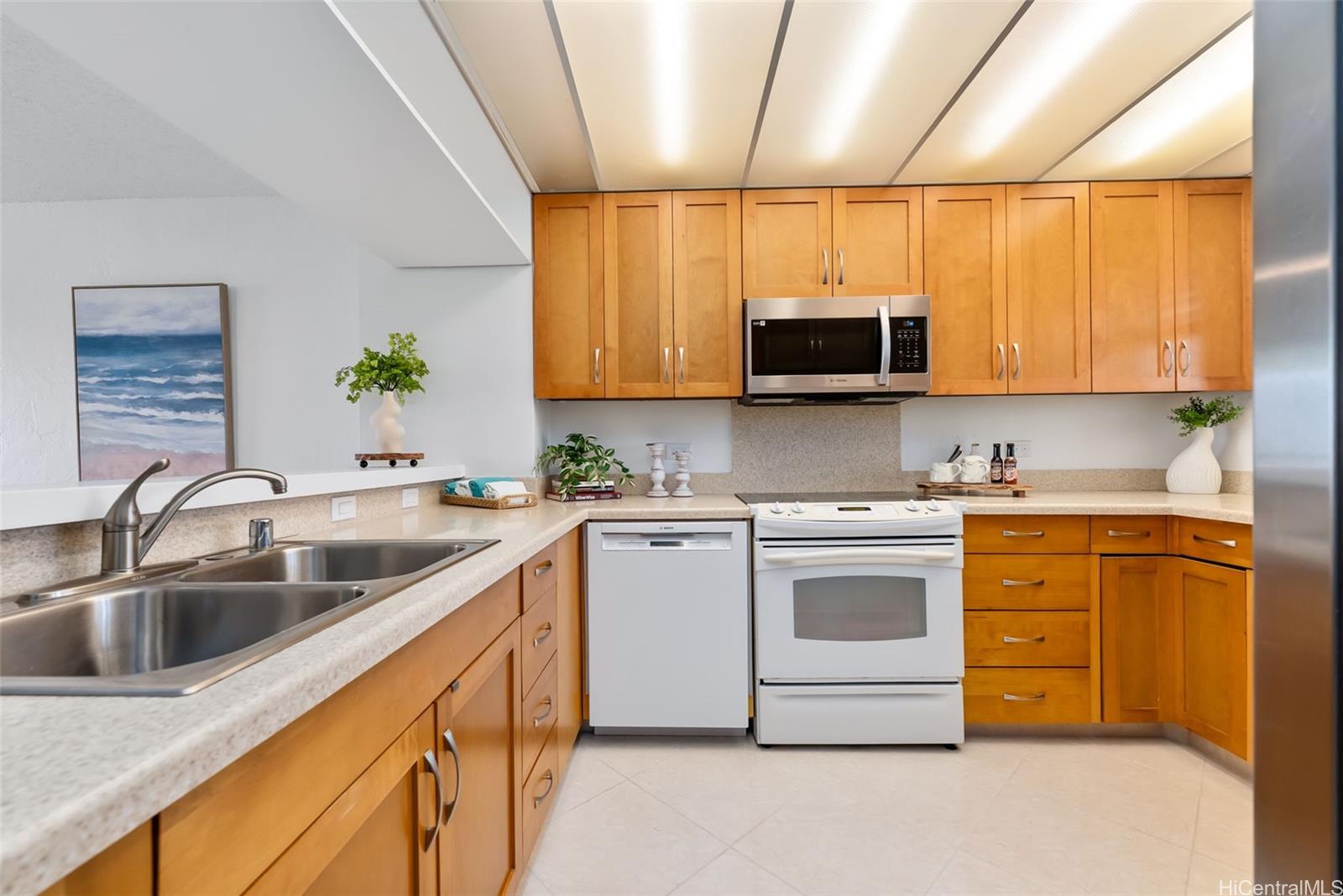 500 Lunalilo Home Road, Unit 25B Honolulu, HI 96825 - Photo 5 of 23 a kitchen with stainless steel appliances granite countertop a sink a stove and a microwave
