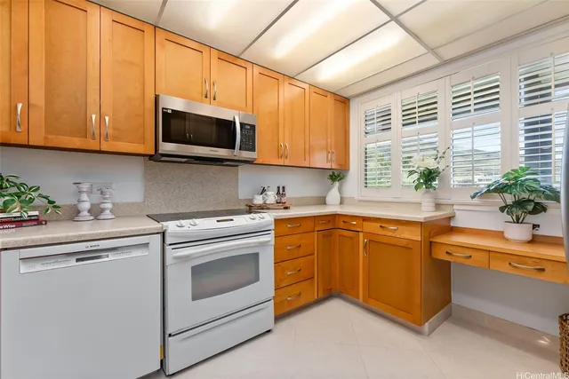 a kitchen with stainless steel appliances granite countertop a sink a stove and cabinets