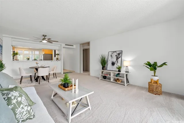 a living room with furniture and a potted plant