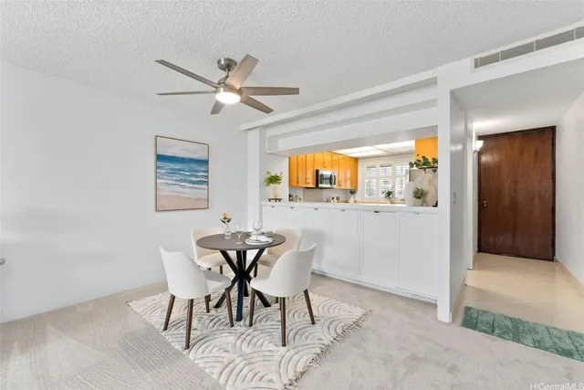 a view of a dining room with furniture and a window