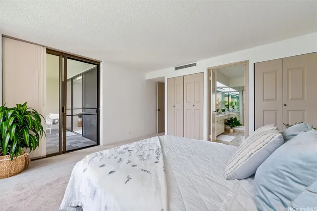 a bedroom with a bed and a large mirror