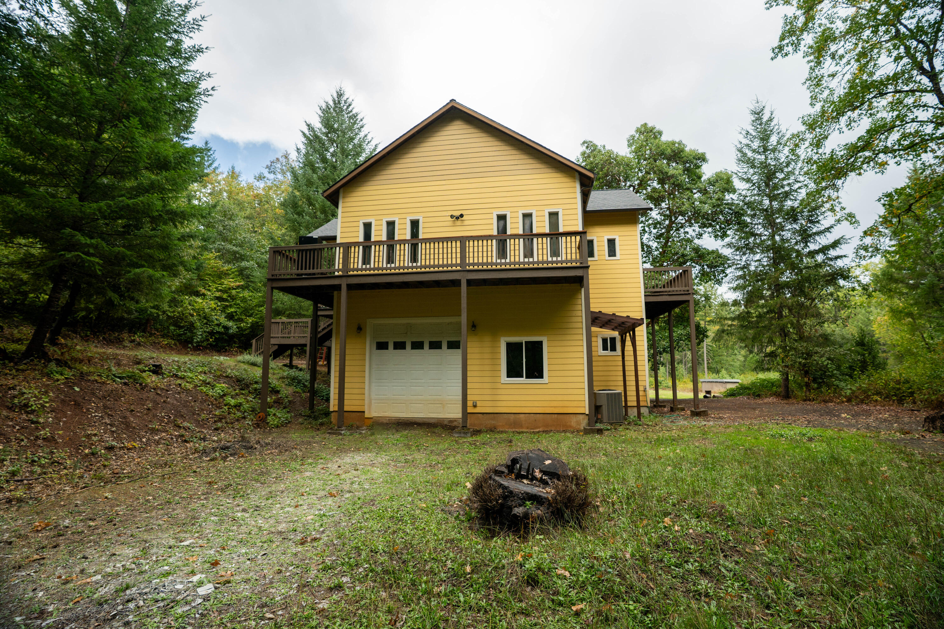 709 Pinewood Way Cave Junction, OR 97523 - Photo 24 of 24 a view of a house with a yard