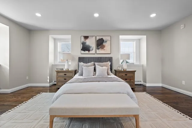 a spacious bedroom with a large bed and a table