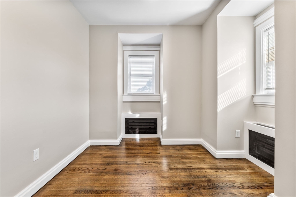 62 Chestnut Street, Unit 2 Saugus, MA 01906 - Photo 17 of 22 a view of an empty room with wooden floor fireplace and a window