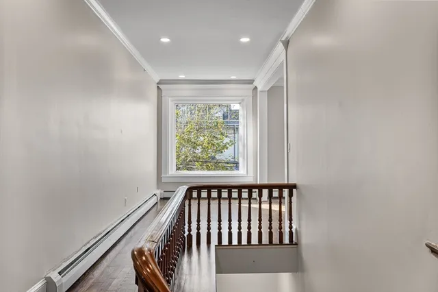 a view of a room with wooden floor and windows