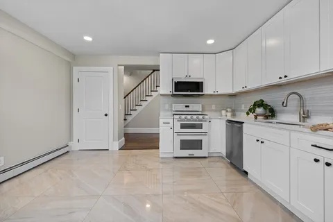 a kitchen with stainless steel appliances a stove sink and cabinets