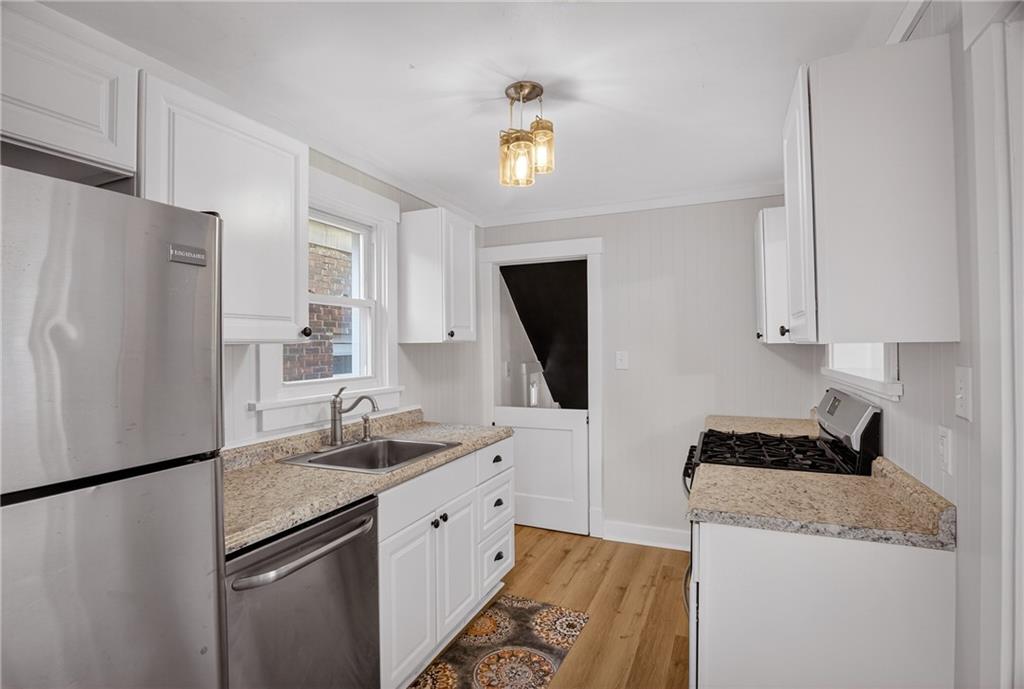 611 Montview Street Pittsburgh, PA 15214 - Photo 13 of 39 a kitchen with a refrigerator sink and stove
