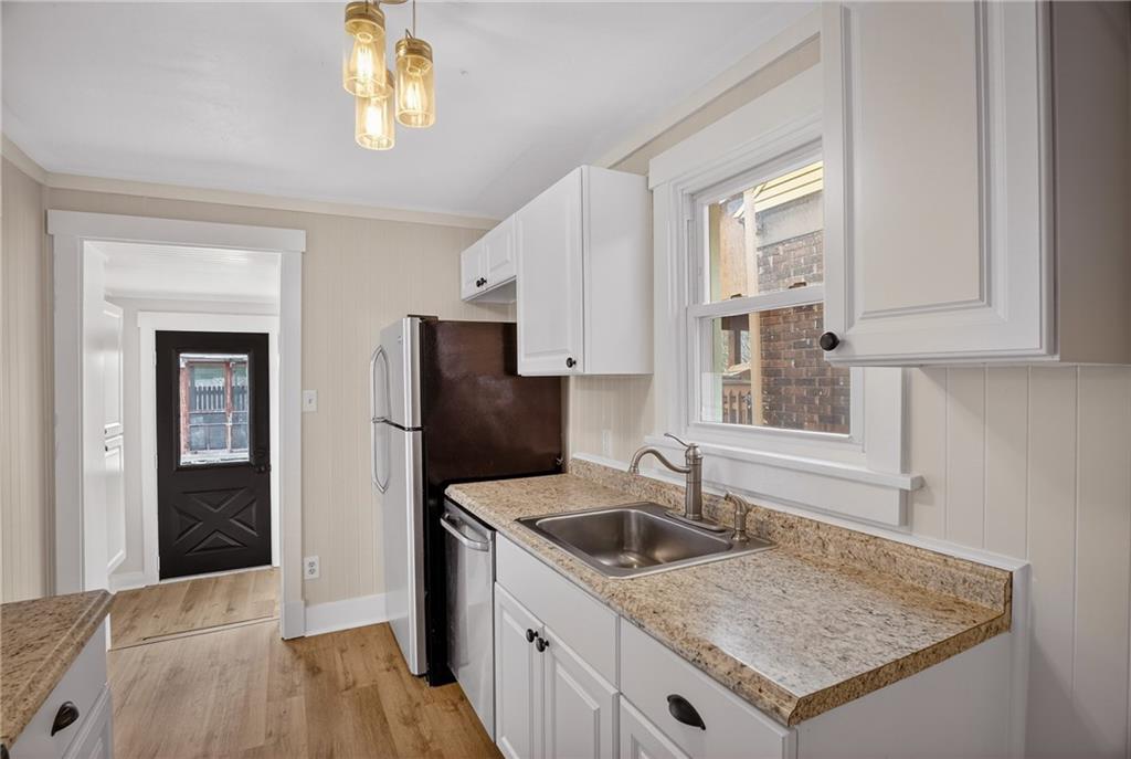 611 Montview Street Pittsburgh, PA 15214 - Photo 16 of 39 a kitchen that has a sink and a stove in it
