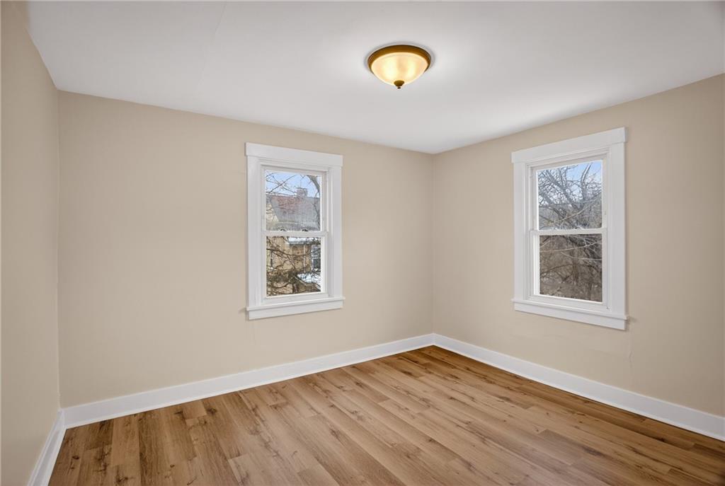 611 Montview Street Pittsburgh, PA 15214 - Photo 22 of 39 a view of an empty room with wooden floor and a window