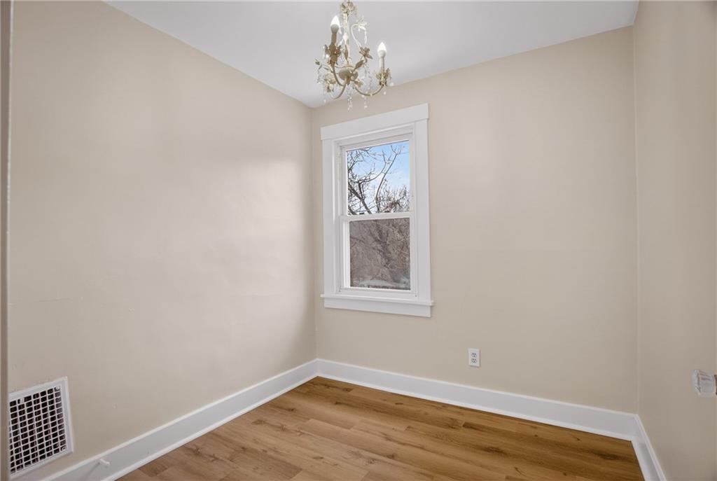 611 Montview Street Pittsburgh, PA 15214 - Photo 24 of 39 wooden floor in an empty room with a window
