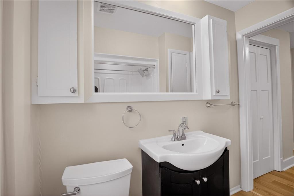 611 Montview Street Pittsburgh, PA 15214 - Photo 27 of 39 a bathroom with a sink a toilet and mirror