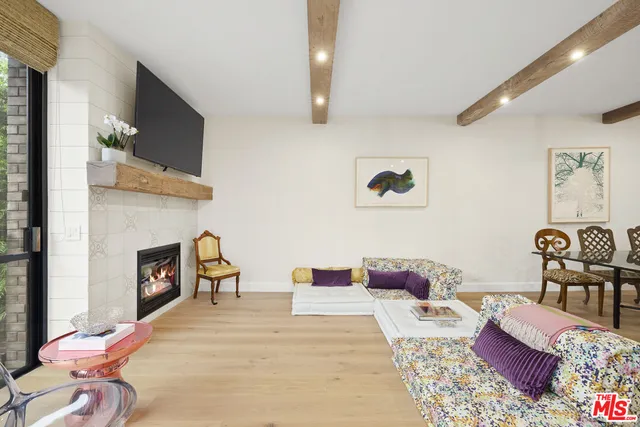 a view of a patio with couches table and chairs and potted plants