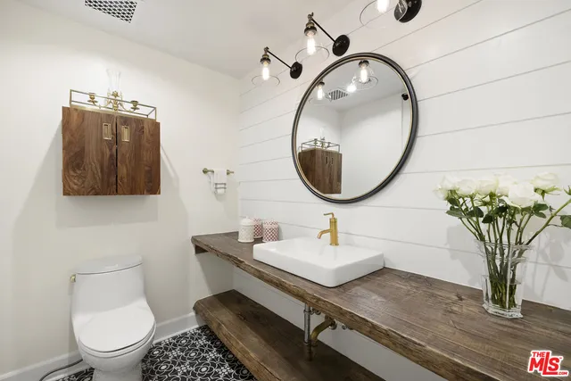 a view of a patio with couches and table and chairs and potted plants