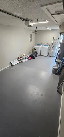 a view of a yard with plants and a fountain