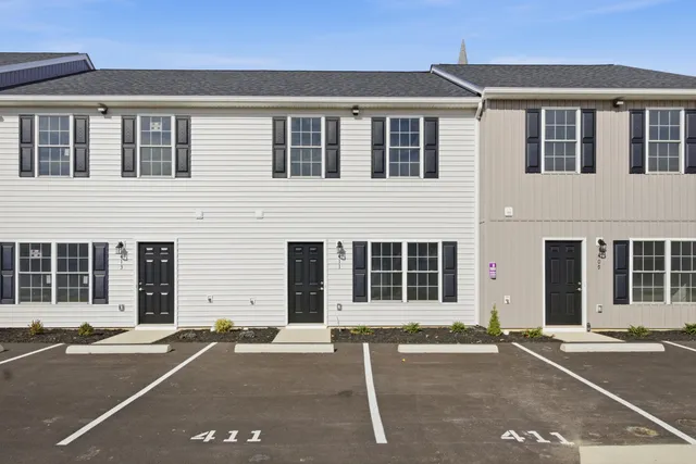 a view of a house with a yard and sitting area