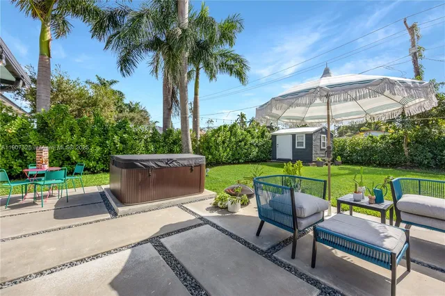 a view of a patio with couches under a yard