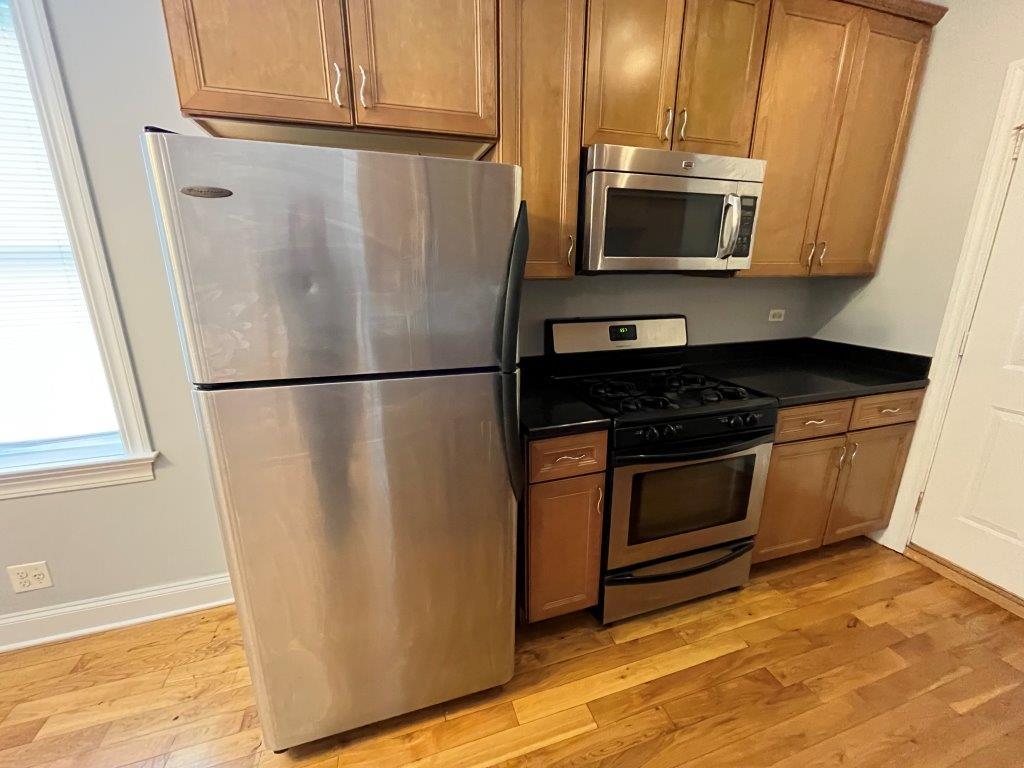 4548 West George Street, Unit 3 Chicago, IL 60641 - Photo 4 of 12 a kitchen with appliances a microwave and cabinets