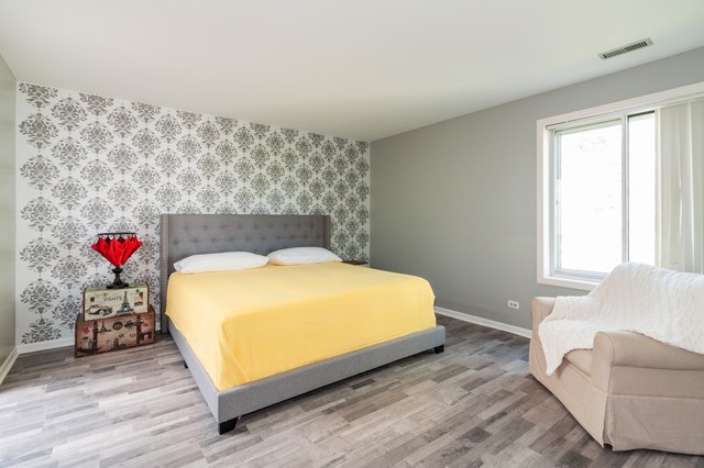 237 Memory Lane, Unit 83 Westmont, IL 60559 - Photo 11 of 16 a bed sitting in a bedroom next to a window with a couch