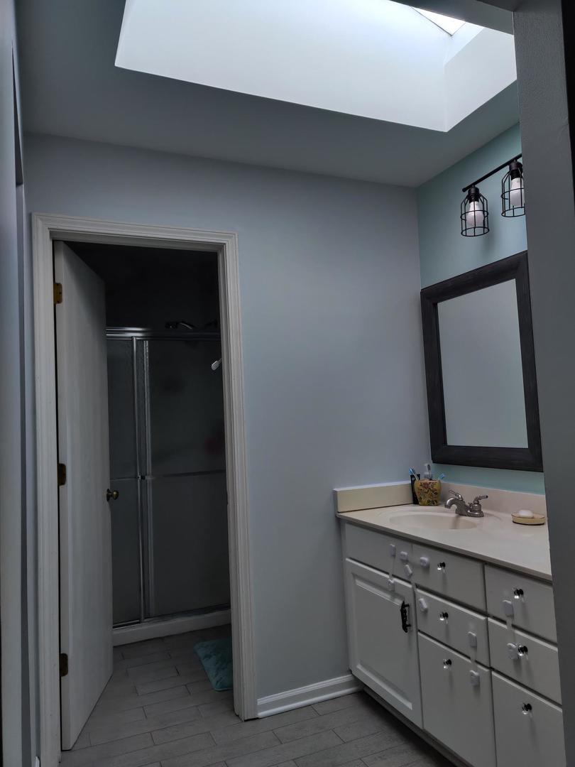 237 Memory Lane, Unit 83 Westmont, IL 60559 - Photo 15 of 16 a bathroom with a double vanity sink and a mirror