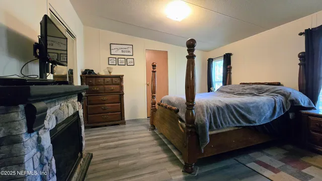 a bedroom with a bed and a mirror