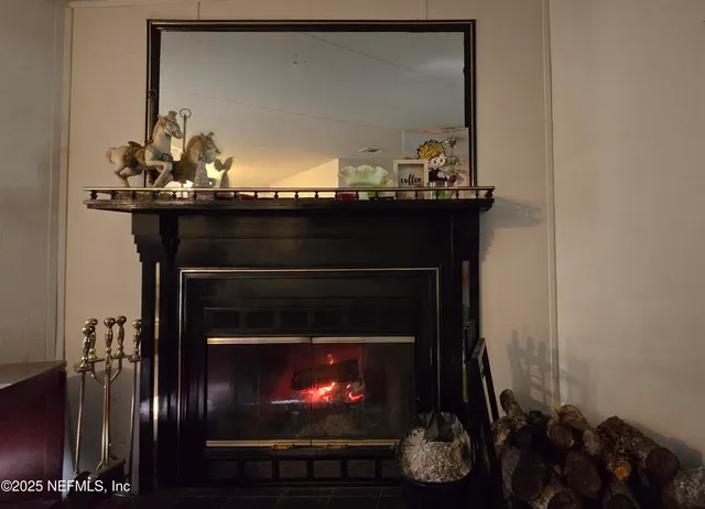 a living room with a fireplace and a potted plant