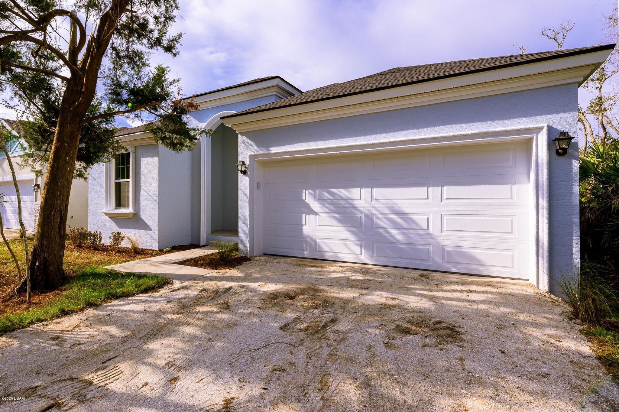 a view of a house with a yard and garage
