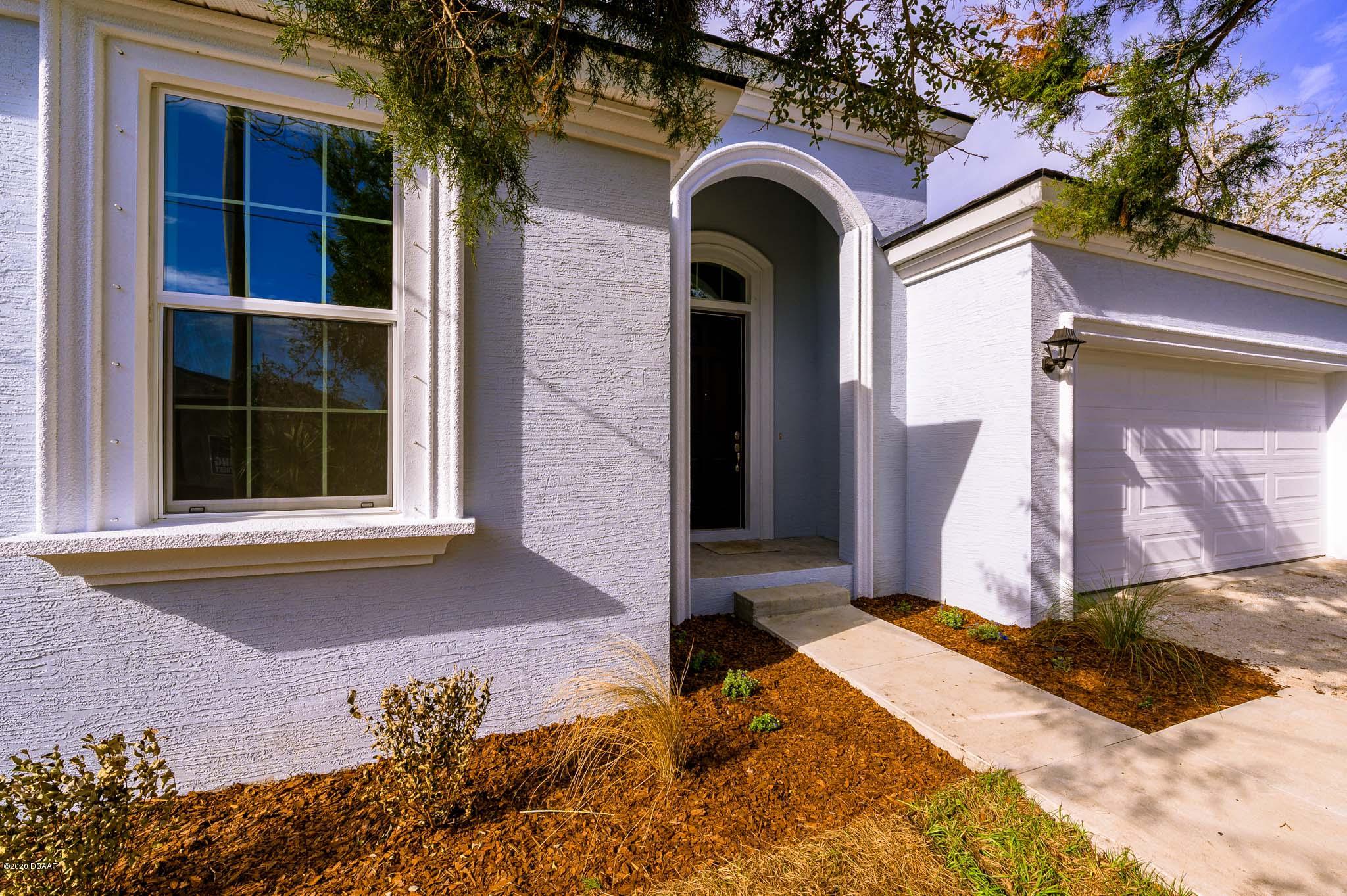 1851 Oak Place Flagler Beach, FL 32136 - Photo 2 of 31 a front view of a house with a yard