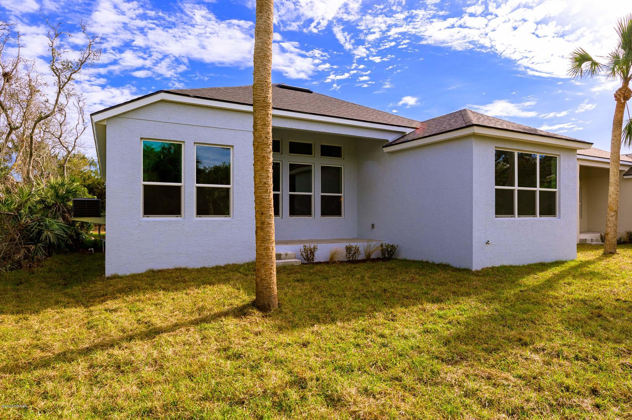 1851 Oak Place Flagler Beach, FL 32136 - Photo 8 of 31 a view of a house with backyard and garden