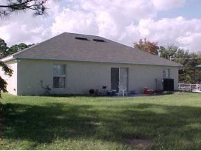2239 Southeast Rambler Palm Bay, FL 32909 - Photo 6 of 6 a backyard of a house with table and chairs