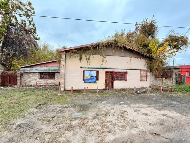 a house that has a tree in front of it