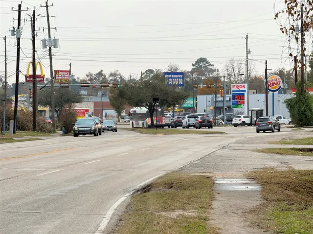 a view of road with a cars park side of road