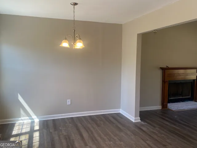 a view of a room with wooden floor and fireplace