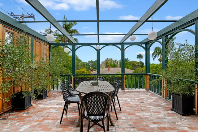 a view of a chairs and table in the balcony