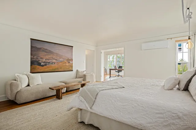 a bedroom with a bed and glass walk in closet