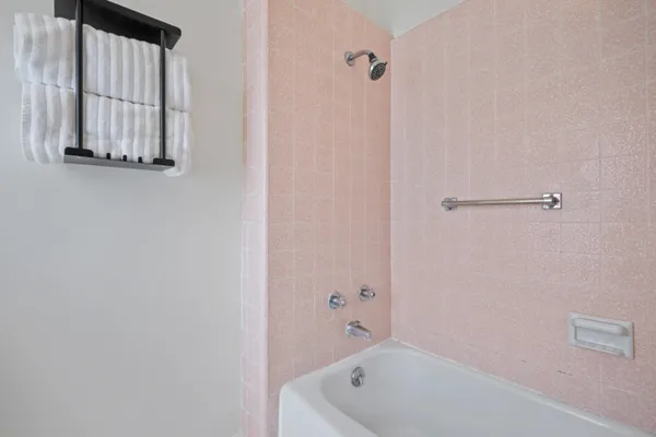 a bathroom with a tub and shower