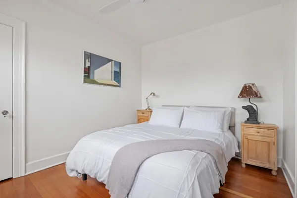 a bedroom with beds and a night stand