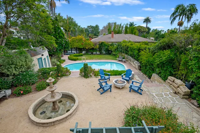 an outdoor space with pool and furniture