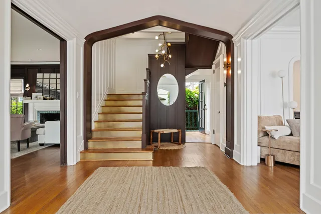 a view of a hallway with wooden floor windows and livingroom
