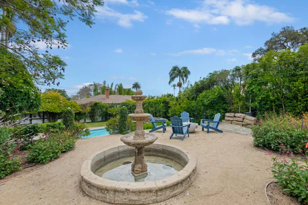 a view of a water fountain with an outdoor seating