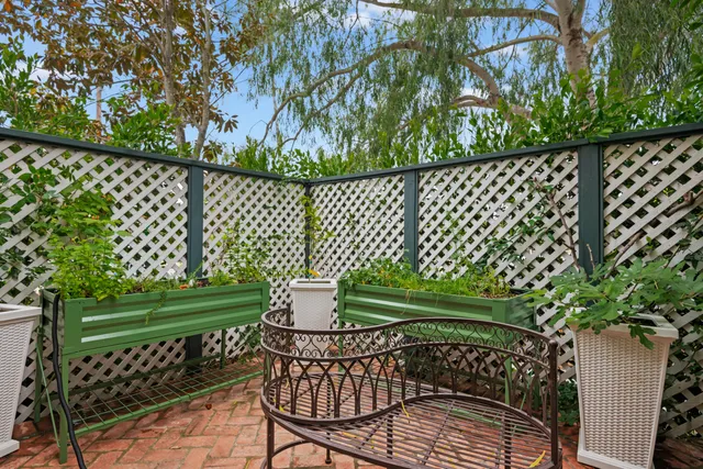 a view of a chair and table in the garden
