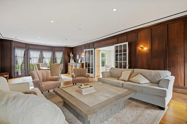 a living room with furniture and large window