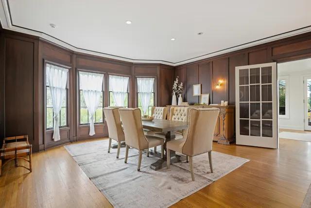 a view of a dining room with furniture and wooden floor