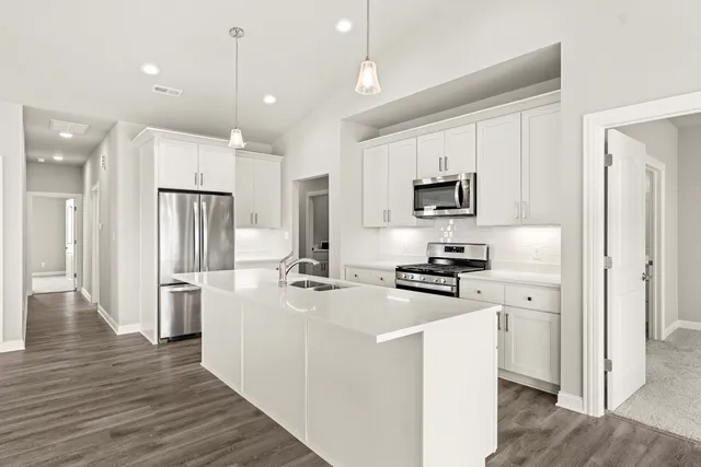 a kitchen with stainless steel appliances a sink stove and refrigerator